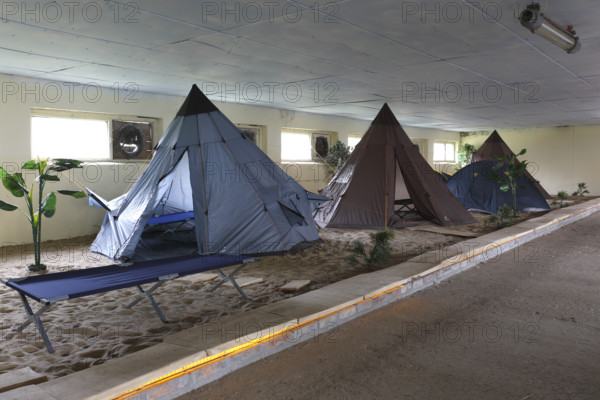 Indoor campsite in a former cattle shed at Fleether Mühle, Müritz National Park, Mecklenburg-Vorpommern, Germany