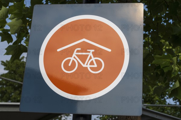 Covered bicycle parking space, sign with logo, Rheda-Wiedenbrück, Westphalia, North Rhine-Westphalia, Germany