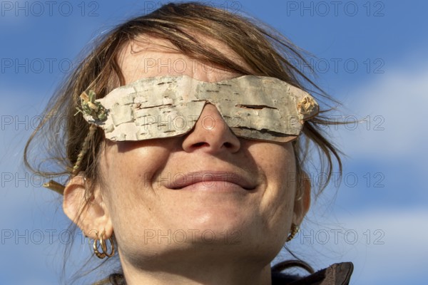 Woman wearing glasses made from birch bark, Gaspesie national park, Province of Quebec, Canada, north America