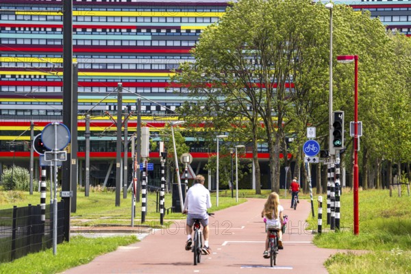 Cycle path through the university campus in Utrecht Science Park, Utrecht University, colourful facade of the Hogeschool Utrecht building, Netherlands