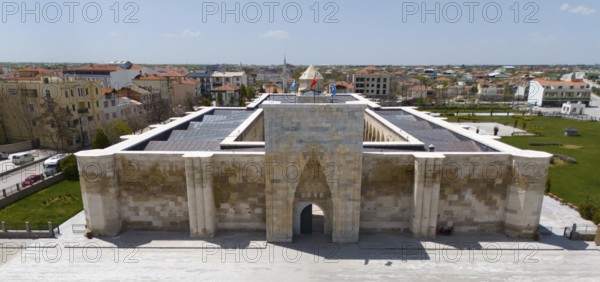 Frontal view of a medieval caravanserai with imposing archway in urban surroundings, aerial view, Sultanhani caravanserai, Sultanhani Kervansaray, Aksaray province, historic Silk Road, Turkey