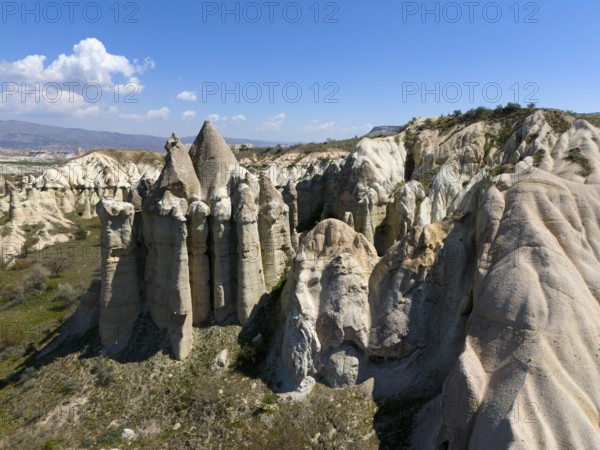 Impressive rock formations under a blue sky in a dry, rocky landscape, aerial view, Love Valley, Göreme National Park, Göreme Tarihî Millî Parki, Nevsehir Province, Nevsehir, Cappadocia, Cappadocia, Cappadocia, Cappadocia, Central Anatolia, Turkey