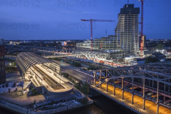 Blue hour aerial view of the Hamburg Elbbrücken U4 underground and suburban railway station and the Elbtower construction site, Hamburg, Germany