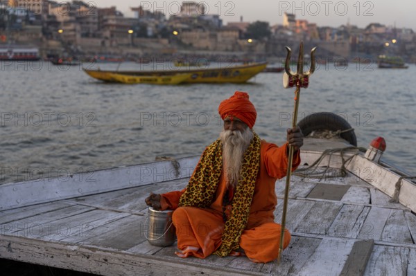 Sadhu with trident on boat, Katesar, Mughalsarai, Uttar Pradesh, India