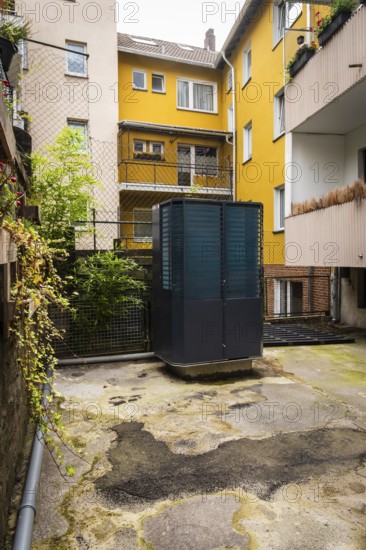 Heat pump in a backyard in Wuppertal, Germany, digitally reworked
