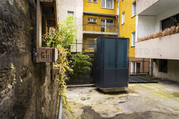 Heat pump in a backyard in Wuppertal, Germany, digitally reworked