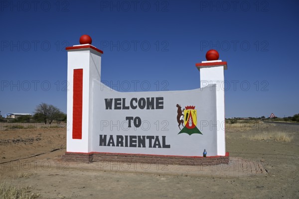 Sign with town coat of arms at the entrance to Mariental, Hardap Region, Namibia