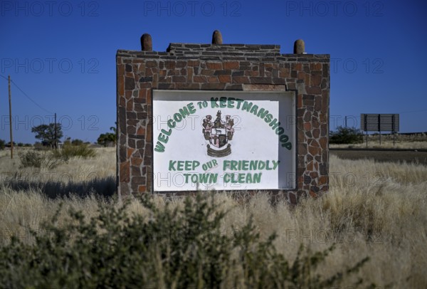 Sign with town coat of arms at the entrance to Keetmanshoop, Karas Region, Namibia