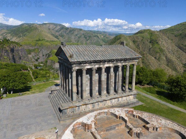 Ancient temple with columns in a green mountain landscape under a blue sky, aerial view, Temple of Garni, Garni, Kotayk province, Armenia