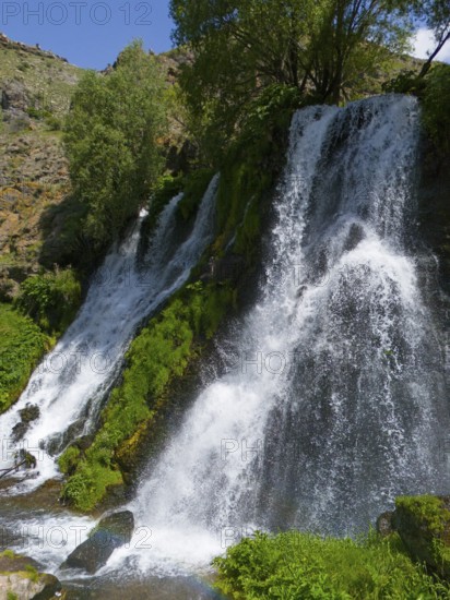 Natural waterfall under a blue sky with lots of greenery, aerial view, Shaki waterfall, Shaki, Syunik province, Armenia