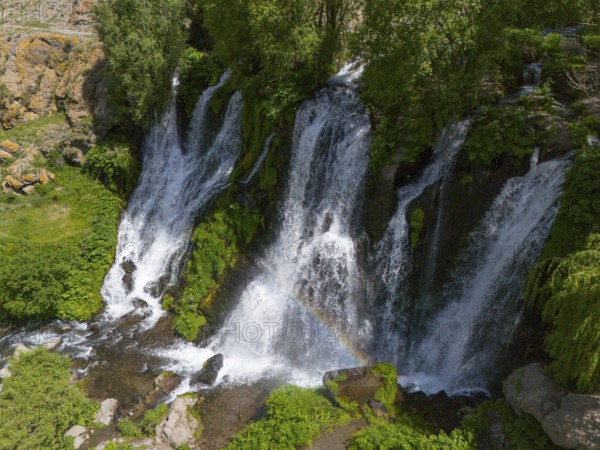 Waterfalls with lush greenery and rainbow in the sunlight, aerial view, Shaki waterfall, Shaki, Syunik province, Armenia