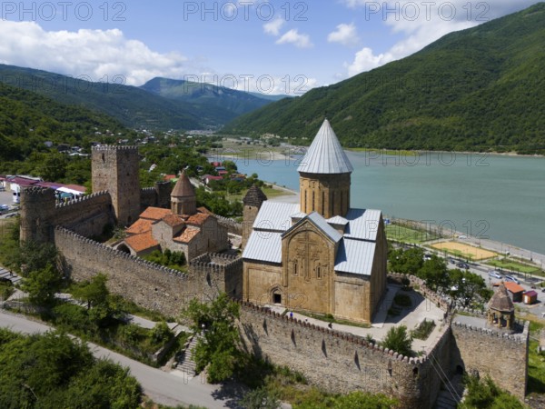 Historic fortress above a reservoir, surrounded by green hills in an idyllic setting, aerial view, Ananuri Castle, Zhinvali Reservoir, Shinvali, Jinvali or Shinvali, Mtskheta-Mtianeti Region, Georgian Military Road, Georgia