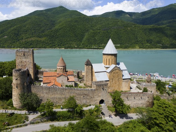 Medieval castle landscape by a body of water with green hills and peaceful atmosphere, aerial view, Ananuri Castle, Zhinvali Reservoir, Shinvali, Jinvali or Shinvali, Mtskheta-Mtianeti region, Georgian Military Road, Georgia