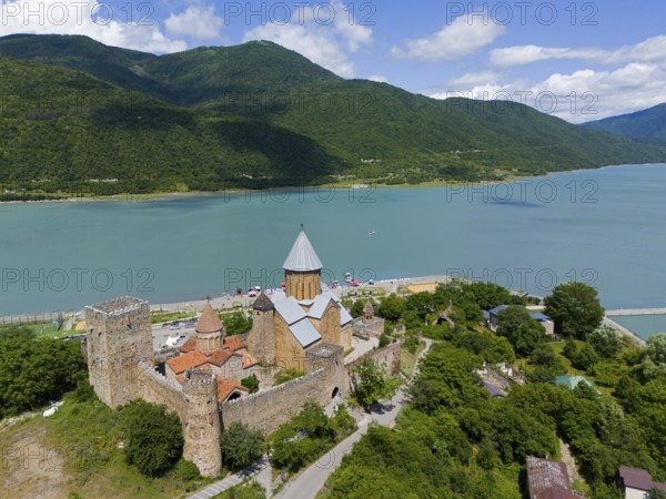 Medieval castle on a lake with surrounding mountains and wooded landscape, aerial view, Ananuri Castle, Zhinvali Reservoir, Shinvali, Jinvali or Shinvali, Mtskheta-Mtianeti region, Georgian Military Road, Georgia