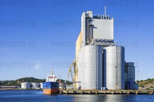 Industrial harbour structures and cargo ship NELLI in the port of Uddevalla, Bohuslän, Västra Götalands län, Sweden, for editorial use only
