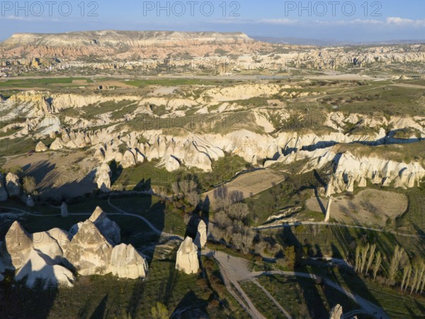 Vast landscape with hills and unique rock formations in the sunlight, aerial view, Göreme National Park, Göreme Tarihî Millî Parki, Nevsehir Province, Nevsehir, Cappadocia, Cappadocia, Cappadocia, Cappadocia, Central Anatolia, Turkey