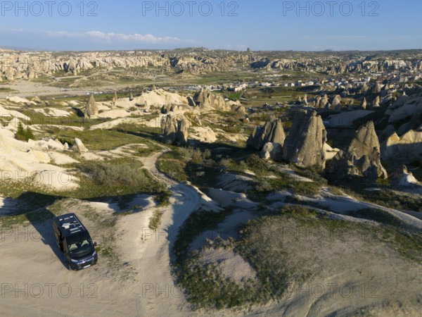 Expansive rocky landscape with a parked van and view of Cappadocia, aerial view, camper, motorhome, Göreme National Park, Göreme Tarihî Millî Parki, Nevsehir Province, Nevsehir, Cappadocia, Cappadocia, Cappadocia, Cappadocia, Central Anatolia, Turkey
