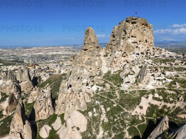 Rocky landscape with ancient rock structures under a clear blue sky in Cappadocia, aerial view, Uchisar Castle, Uçhisar Kalesi, impressive rock formation and fortress, Göreme National Park, Göreme Tarihî Millî, Nevsehir Province, Nevsehir, Cappadocia, Cappadocia, Kapadokya, Cappadocia, Central Anatolia, Turkey