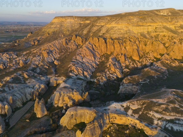 Breathtaking rock formations in the evening light in a vast landscape, aerial view, Göreme National Park, Göreme Tarihî Millî Parki, Nevsehir Province, Nevsehir, Cappadocia, Cappadocia, Cappadocia, Cappadocia, Central Anatolia, Turkey