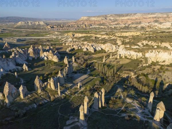Aerial view of a rocky landscape in Cappadocia with striking rock formations and valleys under a blue sky, Göreme National Park, Göreme Tarihî Millî Parki, Nevsehir Province, Nevsehir, Cappadocia, Cappadocia, Kapadokya, Cappadocia, Central Anatolia, Turkey