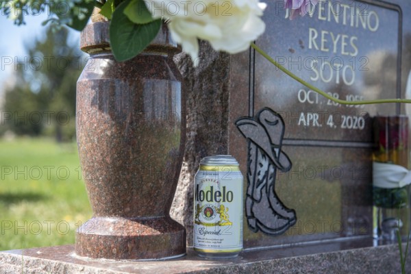 Wheat Ridge, Colorado - Graves decorated for Easter in Crown Hill Cemetery, also known as Olinger Cemetery. One grave has a can of Modelo Especial beer