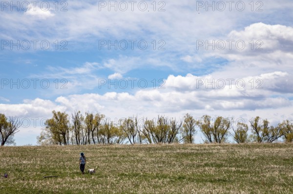 Wheat Ridge, Colorado - A woman walks with her dog in Crown Hill Park on Eastern Sunday