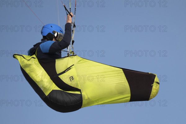 A paraglider or paraglider in front of a blue sky, near Hvide Sande, North Sea, Denmark