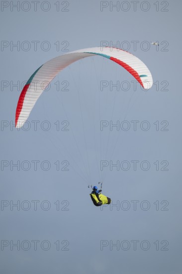A paraglider or paraglider in front of a blue sky, near Hvide Sande, North Sea, Denmark