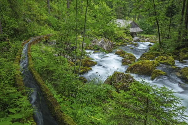 Golling watermill from above at the waterfall with the water pipe. Traditional mill in an alpine landscape, Golling an der Salzach, Austria