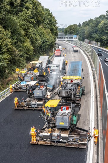 Rehabilitation of the A52 motorway near Essen, an 8 km long section between the Essen-Kettwig junction and the Essen-Ost motorway junction was completely renovated over a period of 9 years, 6 lanes, new drainage pipes, carriageway, bridges, noise barriers, traffic facilities, here the last section, direction Düsseldorf, new carriageway surface, laying of porous asphalt, whispering asphalt, at the Essen-Rüttenscheid junction, North Rhine-Westphalia, Germany