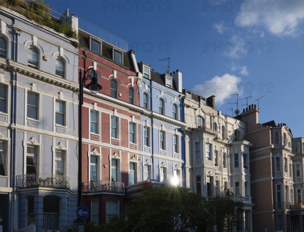 Terraced houses, townhouses with different, colourfully painted facades under a blue sky, Portobello Road, Notting Hill, London, England, Great Britain