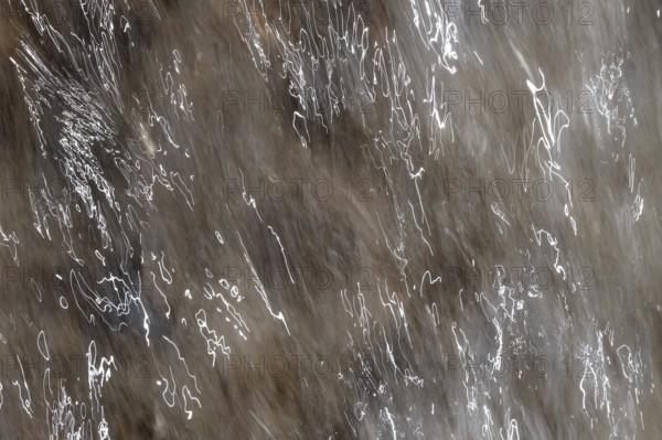 Close-up of moving water with a pattern of light and shadow, light trails, long exposure, North Sea, Denmark