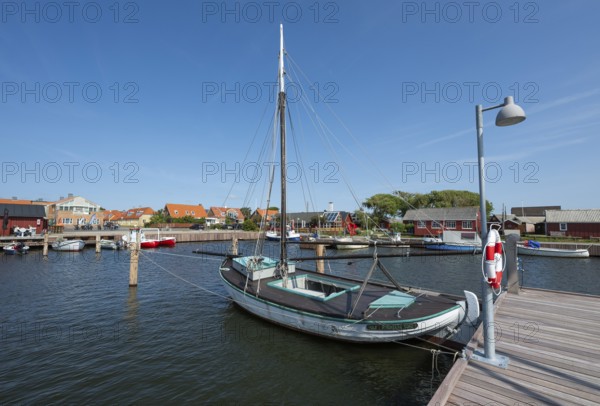 Old sailing boat in the harbour at a jetty, Ringkøbing, Ringkøbing Fjord, Denmark
