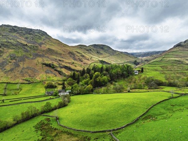 Farms and Mountains over road A591 from a drone, Grasmere Lake, Grasmere, Ambleside, Lake District, Westmorland, Cumbria, UK