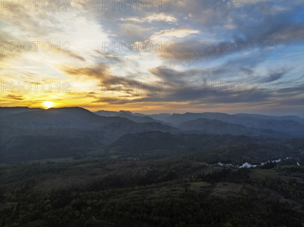 Sunset over Mountains and Coniston Water from drone, Lake District National Park, Cumbria, England, United Kingdom
