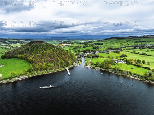 Farms and mountains over Ullswater Lake from drone, Pooley Bridge, Lake District National Park, Cumbria, England, United Kingdom