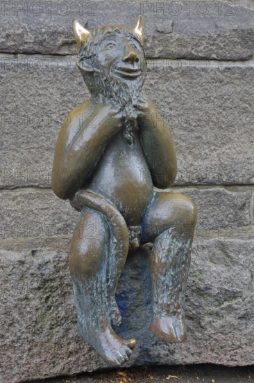 Sculpture Devil by Rolf Goerler 1999 sitting on the Devil's Stone, bronze sculpture, modern art, St. Mary's Church, Old Town, Lübeck, Schleswig-Holstein, Germany