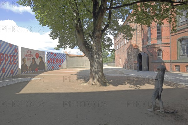 European Hanseatic Museum with sculpture Mary Magdalene by Kiki Smith 1994, banner, historic brick building, inner courtyard, Marstallweg, Old Town, Lübeck, Schleswig-Holstein, Germany