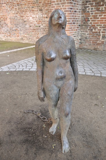 Sculpture Mary Magdalene by Kiki Smith 1994, Wild Woman, bronze sculpture, modern art, female figure with shackles, shackles, bound, chained, chained, attached, chain, naked, standing, life-size, European Hanseatic Museum, Old Town, Lübeck, Schleswig-Holstein, Germany
