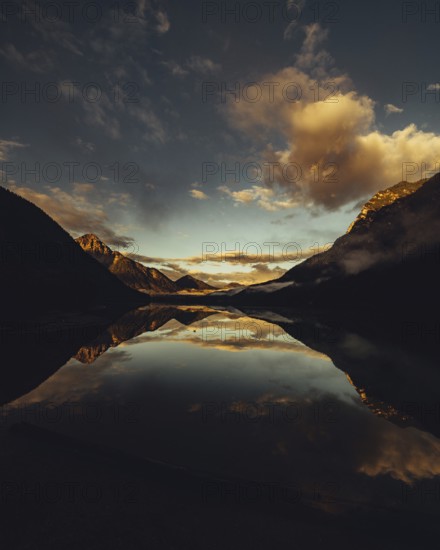 Sunrise with reflections in Lake Heiterwanger See in Tyrol in the Alps in Austria