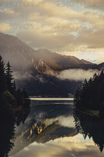Sunrise with reflections and alpenglow in Lake Heiterwanger See in Tyrol in the Alps in Austria