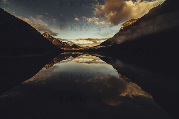 Sunrise with reflections in Lake Heiterwanger See in Tyrol in the Alps in Austria