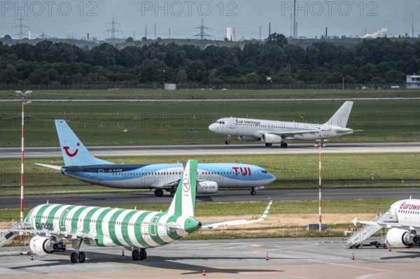 Düsseldorf Airport, Condor Airbus A321-200, aircraft on the apron, TUIFly Boeing 737 on the way to take-off, Eurowings Airbus on take-off, North Rhine-Westphalia, Germany