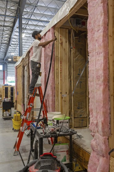 Romulus, Michigan - Workers build apartments in Ginosko Modular 's factory using modular construction methods. The units will be assembled into an apartment building in Detroit for low to moderate income households