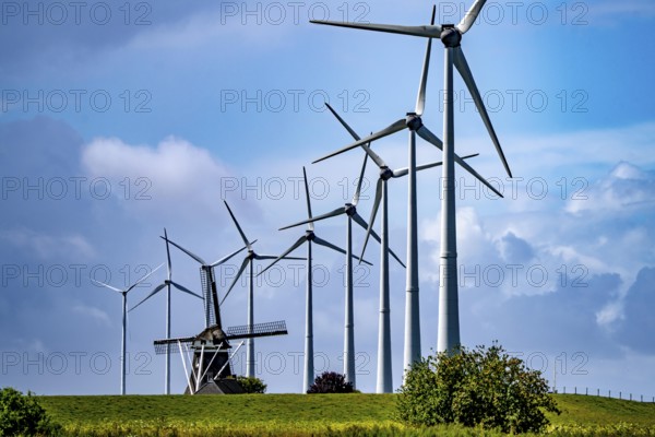 Westereems and Growind wind farms, over 80 wind turbines in total, at the Eemshaven seaport, province of Groningen, in the north-west of the Netherlands, historic Goliath windmill from 1897