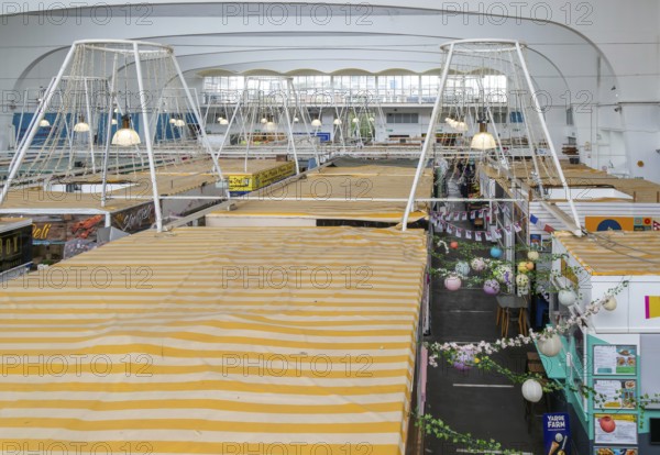 Raised view over roofs of market stalls in Market Building or Pannier Market, city of Plymouth, Devon, England, UK