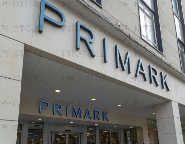 Signs above entrance doorway to Primark shop store, Torquay, Devon, England, UK