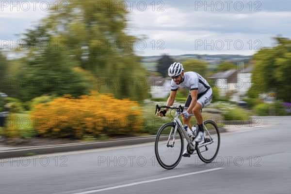 A cyclist, racing cyclist rides his racing bike fast on a road through a rural area, AI generated, AI generated