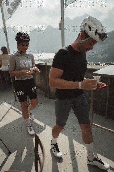 Young man taking a coffee break while riding his racing bike on Lake Garda. Sunny weather and dolce vita