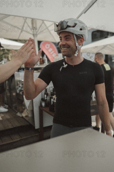 Young man riding a racing bike on Lake Garda. Sunny weather and dolce vita